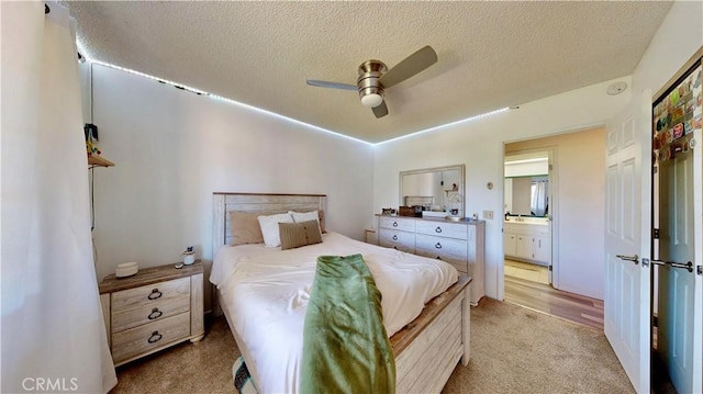 15233 Olive St, Hesperia, CA 92345 - bedroom featuring light carpet, a textured ceiling, a ceiling fan, and ensuite bath