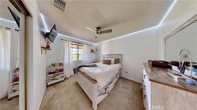 15233 Olive St, Hesperia, CA 92345 - bedroom with light colored carpet, a textured ceiling, and a ceiling fan