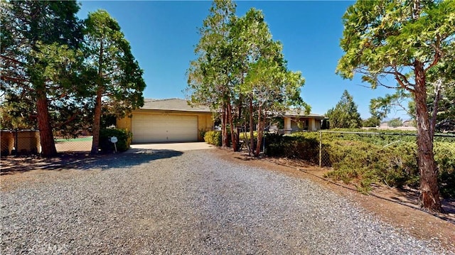 15233 Olive St, Hesperia, CA 92345 - view of front of house with gravel driveway and an attached garage