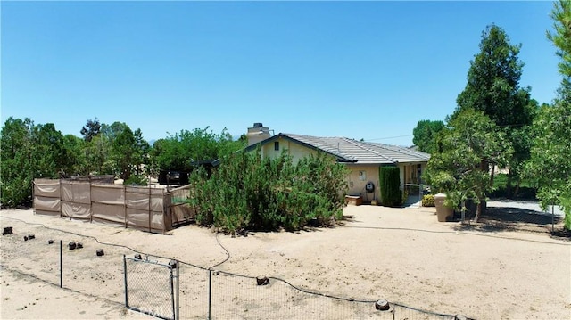 15233 Olive St, Hesperia, CA 92345 - view of home's exterior featuring stucco siding and a chimney