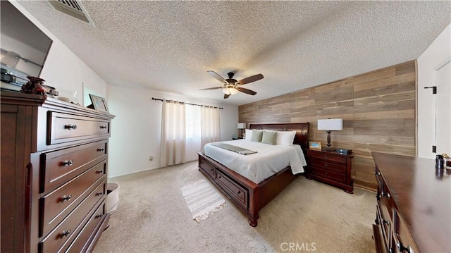 15233 Olive St, Hesperia, CA 92345 - bedroom with wood walls, light carpet, a textured ceiling, an accent wall, and ceiling fan