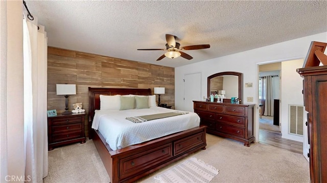 15233 Olive St, Hesperia, CA 92345 - bedroom with light carpet, wood walls, a textured ceiling, and ceiling fan