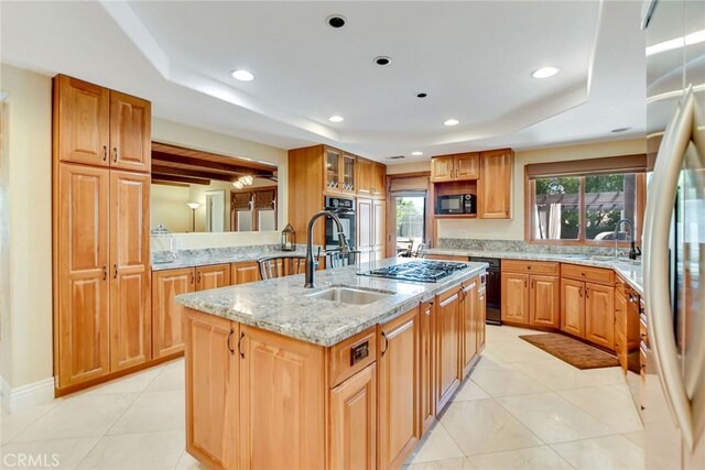 462 Pomello Dr, Claremont, CA 91711 - kitchen with black appliances, a center island with sink, plenty of natural light, a raised ceiling, and recessed lighting