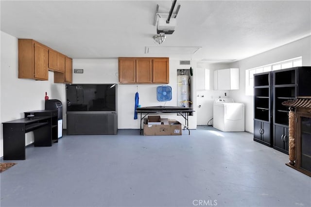 26969 Lakeview Dr, Helendale, CA 92342 - garage with washer / dryer, strapped water heater, and a garage door opener