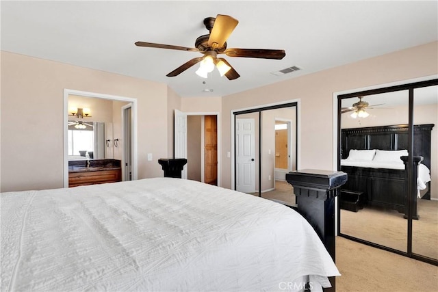 26969 Lakeview Dr, Helendale, CA 92342 - bedroom with light colored carpet, a ceiling fan, ensuite bath, and multiple closets