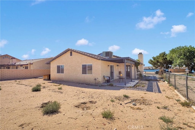 26969 Lakeview Dr, Helendale, CA 92342 - back of house with a fenced backyard, a chimney, and stucco siding