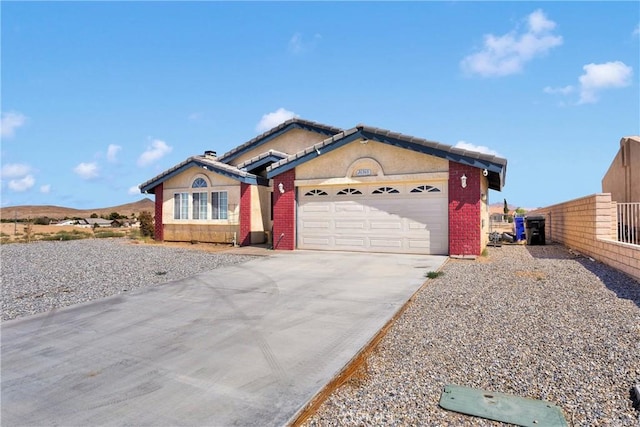 26969 Lakeview Dr, Helendale, CA 92342 - ranch-style home with an attached garage, concrete driveway, and brick siding