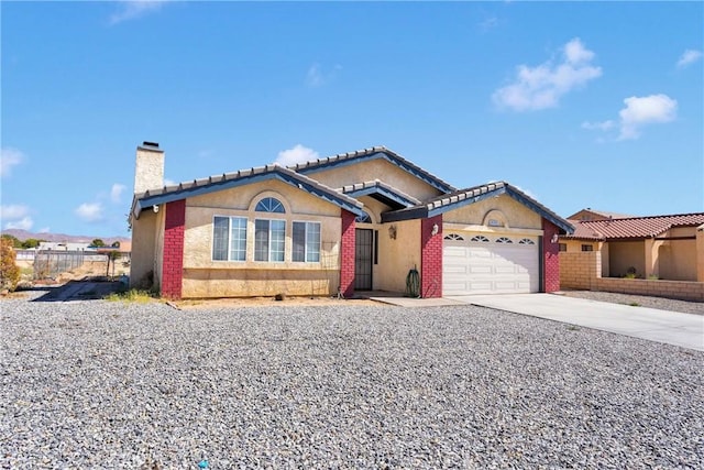 26969 Lakeview Dr, Helendale, CA 92342 - view of front of house with driveway, a chimney, an attached garage, and stucco siding
