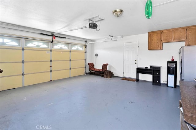 26969 Lakeview Dr, Helendale, CA 92342 - garage with freestanding refrigerator and a garage door opener
