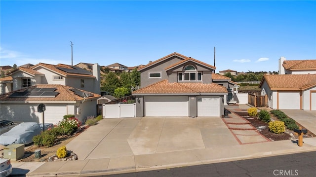 40236 Holden Cir, Temecula, CA 92591 - view of front facade with a gate, stucco siding, a tile roof, concrete driveway, and a residential view