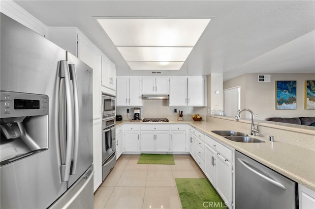 40236 Holden Cir, Temecula, CA 92591 - kitchen with appliances with stainless steel finishes, under cabinet range hood, light countertops, white cabinets, and light tile patterned floors