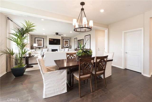 11829 Confluence Dr, Jurupa Valley, CA 91752 - dining area with recessed lighting, a ceiling fan, a fireplace, a chandelier, and dark wood-style flooring
