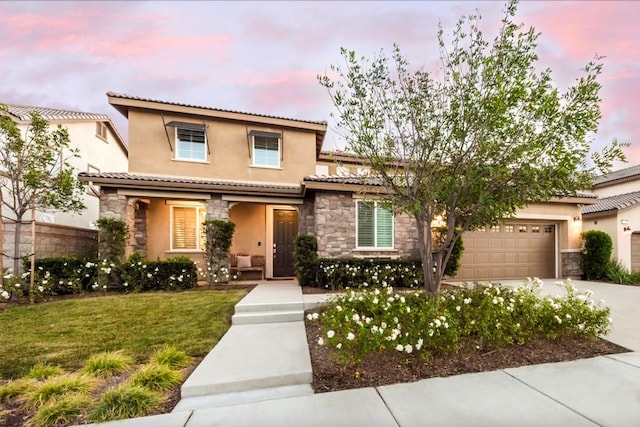 11829 Confluence Dr, Jurupa Valley, CA 91752 - mediterranean / spanish home featuring stone siding, driveway, stucco siding, an attached garage, and a tiled roof