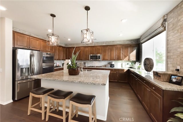 11829 Confluence Dr, Jurupa Valley, CA 91752 - kitchen with stainless steel appliances, tasteful backsplash, light stone counters, dark wood-style flooring, and recessed lighting
