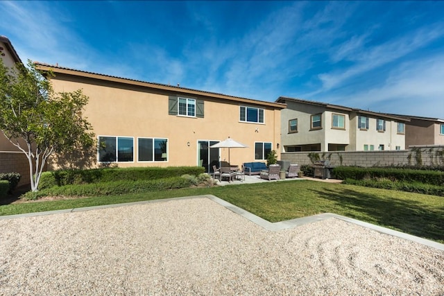 11829 Confluence Dr, Jurupa Valley, CA 91752 - back of property with outdoor lounge area, stucco siding, and a patio