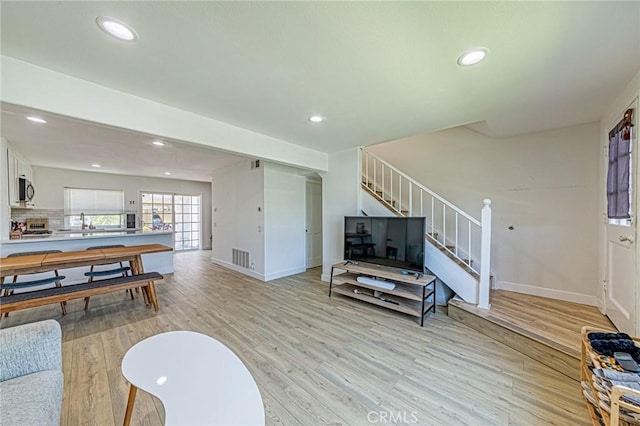 68 Timber Run Unit 45, Irvine, CA 92614 - living area with light wood finished floors, stairway, and recessed lighting