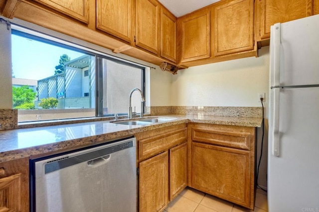 6180 Agee St Unit 159, University City, CA 92122 - kitchen featuring freestanding refrigerator, stainless steel dishwasher, brown cabinetry, light tile patterned flooring, and light stone countertops