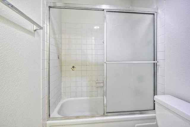 6180 Agee St Unit 159, University City, CA 92122 - bathroom with a textured wall and combined bath / shower with glass door