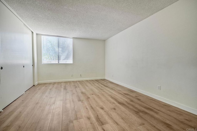 6180 Agee St Unit 159, University City, CA 92122 - empty room featuring a textured ceiling and light wood-type flooring