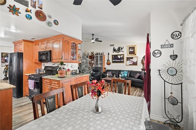 44505 Shadowcrest Dr, Lancaster, CA 93536 - dining space featuring a ceiling fan, light wood-style flooring, and lofted ceiling