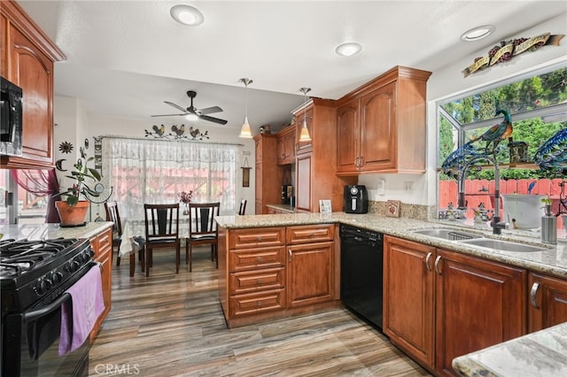 44505 Shadowcrest Dr, Lancaster, CA 93536 - kitchen with black appliances, healthy amount of natural light, a ceiling fan, light stone counters, and recessed lighting