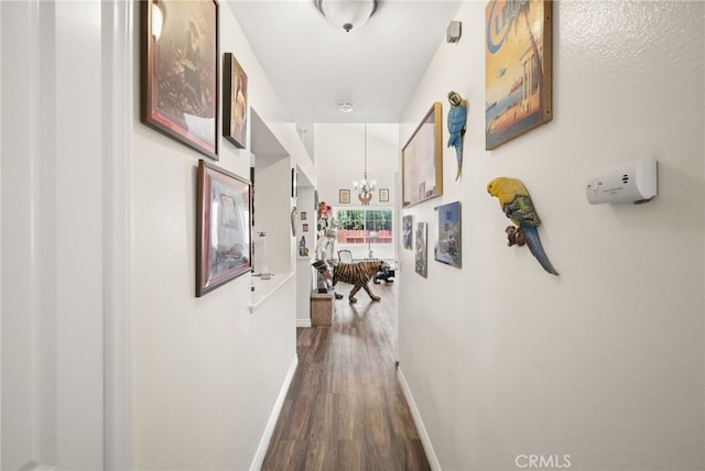 44505 Shadowcrest Dr, Lancaster, CA 93536 - hallway featuring dark wood-style floors and a chandelier