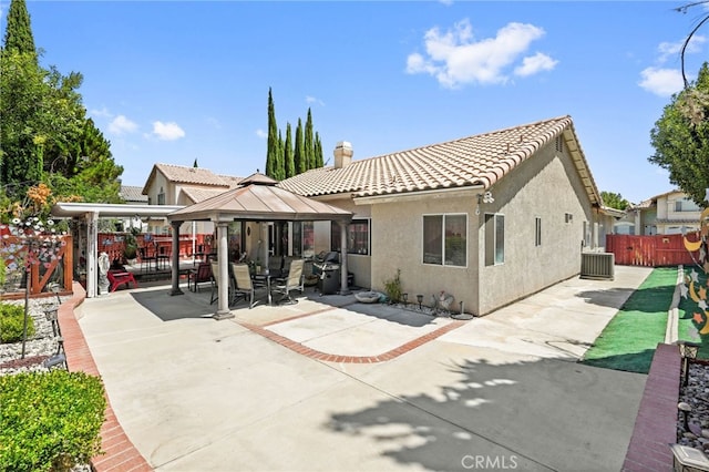44505 Shadowcrest Dr, Lancaster, CA 93536 - rear view of property featuring a gazebo, stucco siding, a patio, a tile roof, and a chimney