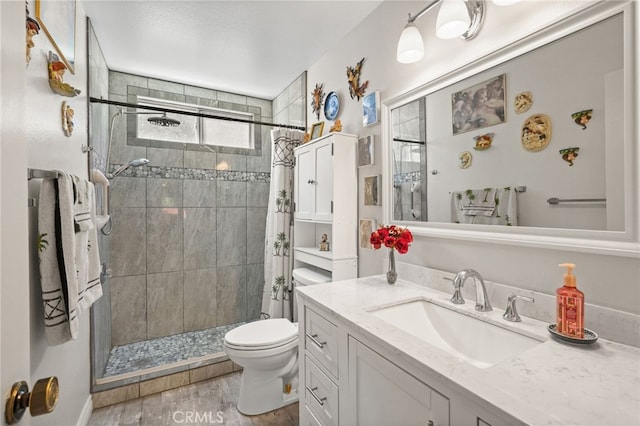 44505 Shadowcrest Dr, Lancaster, CA 93536 - full bathroom with a stall shower, vanity, and wood finished floors