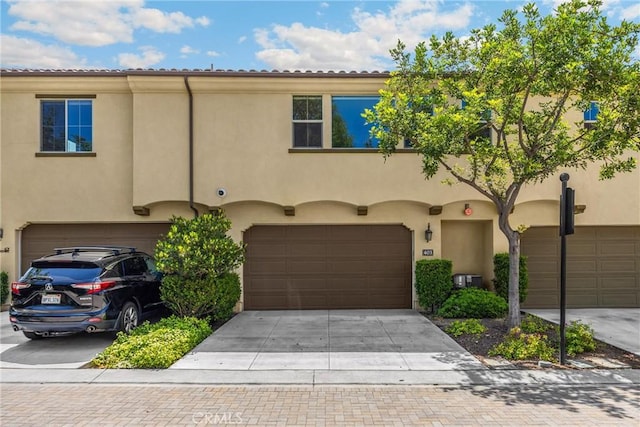 403 Sevilla Dr, Brea, CA 92823 - view of front of property with an attached garage and stucco siding