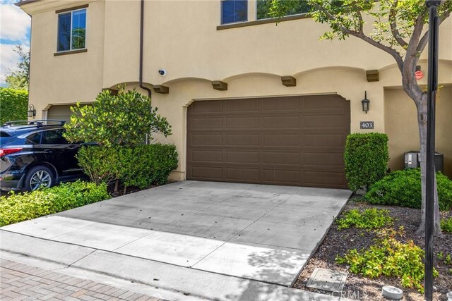 403 Sevilla Dr, Brea, CA 92823 - view of front facade featuring stucco siding, a garage, and concrete driveway