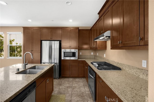 403 Sevilla Dr, Brea, CA 92823 - kitchen with appliances with stainless steel finishes, under cabinet range hood, light stone counters, and recessed lighting