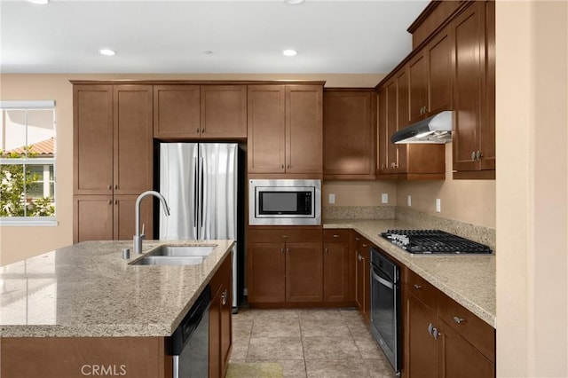 403 Sevilla Dr, Brea, CA 92823 - kitchen featuring stainless steel appliances, under cabinet range hood, an island with sink, light stone countertops, and recessed lighting