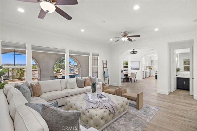 19 Dennis Ln, Ladera Ranch, CA 92694 - living room featuring a ceiling fan, arched walkways, ornamental molding, recessed lighting, and light wood-style floors