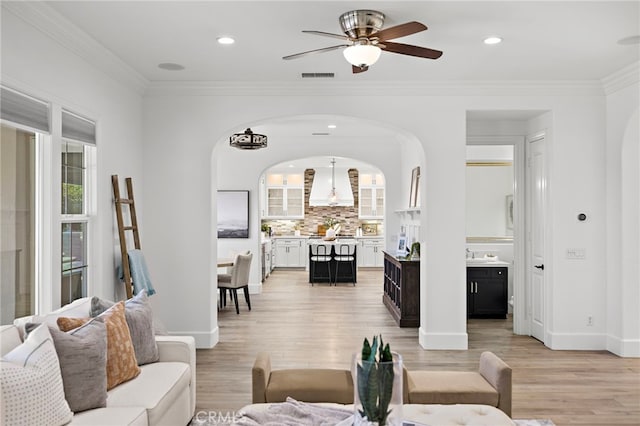 19 Dennis Ln, Ladera Ranch, CA 92694 - living area featuring arched walkways, light wood-style flooring, a ceiling fan, ornamental molding, and recessed lighting