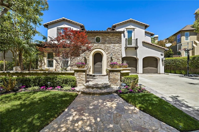 19 Dennis Ln, Ladera Ranch, CA 92694 - mediterranean / spanish-style house with a garage, stucco siding, driveway, a tiled roof, and stone siding