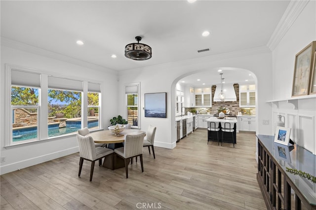 19 Dennis Ln, Ladera Ranch, CA 92694 - dining room featuring arched walkways, recessed lighting, light wood-style floors, and ornamental molding