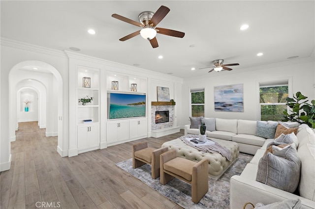 19 Dennis Ln, Ladera Ranch, CA 92694 - living area featuring ceiling fan, crown molding, recessed lighting, a glass covered fireplace, and arched walkways