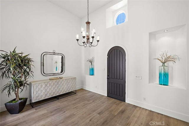 19 Dennis Ln, Ladera Ranch, CA 92694 - foyer entrance featuring a chandelier, wood finished floors, and high vaulted ceiling