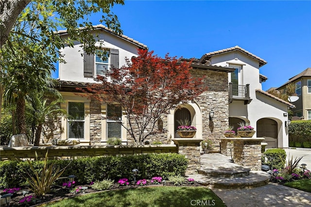 19 Dennis Ln, Ladera Ranch, CA 92694 - mediterranean / spanish-style home featuring a balcony, stone siding, a tiled roof, and stucco siding