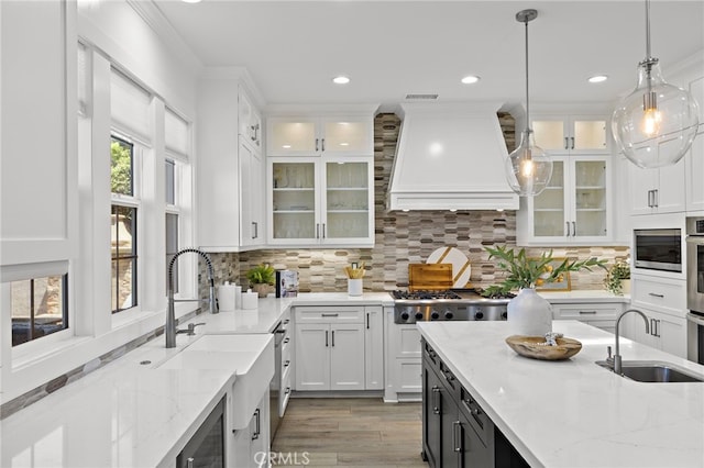 19 Dennis Ln, Ladera Ranch, CA 92694 - kitchen featuring custom exhaust hood, appliances with stainless steel finishes, white cabinets, recessed lighting, and crown molding