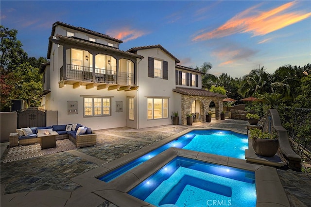19 Dennis Ln, Ladera Ranch, CA 92694 - rear view of property with a balcony, an outdoor living space, an in-ground hot tub, a patio area, and stucco siding