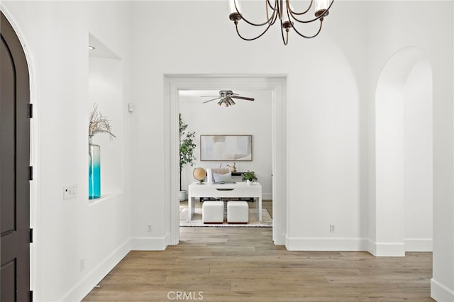 19 Dennis Ln, Ladera Ranch, CA 92694 - foyer featuring arched walkways, light wood-style floors, ceiling fan, and a chandelier