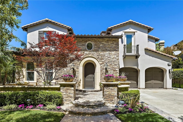 19 Dennis Ln, Ladera Ranch, CA 92694 - mediterranean / spanish-style home with a balcony, a tile roof, an attached garage, stone siding, and stucco siding