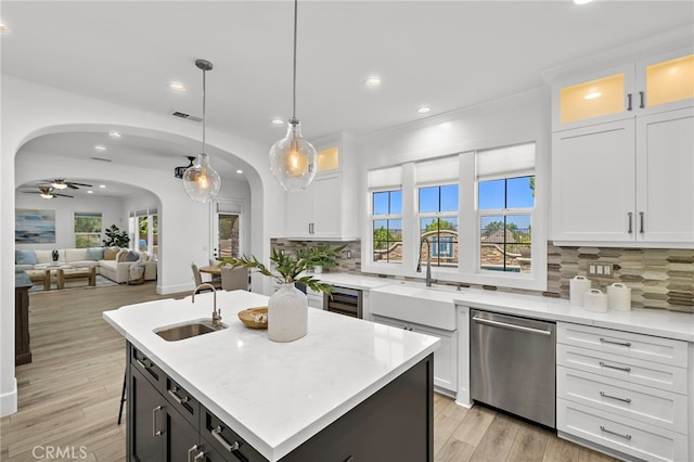 19 Dennis Ln, Ladera Ranch, CA 92694 - kitchen featuring dishwasher, arched walkways, recessed lighting, white cabinetry, and backsplash