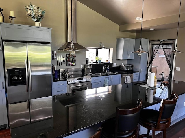 32688 Taspa Ct, Pauma Valley, CA 92061 - kitchen with appliances with stainless steel finishes, dark countertops, healthy amount of natural light, a breakfast bar area, and vaulted ceiling