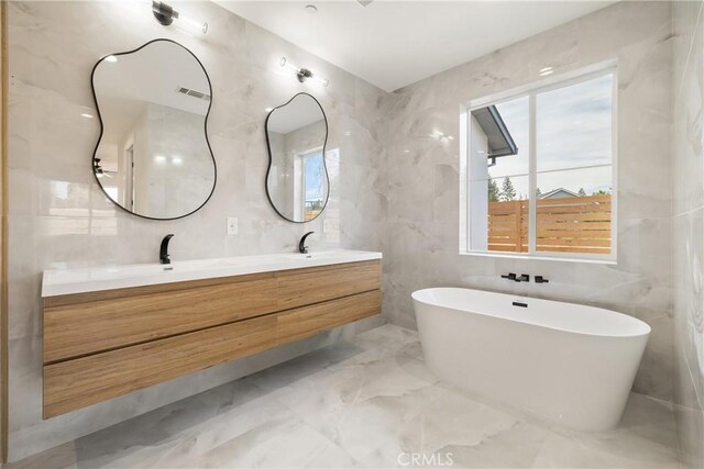 6638 Dolores Dr, Paradise, CA 95969 - bathroom with tile walls, marble tiled flooring, double vanity, and a soaking tub
