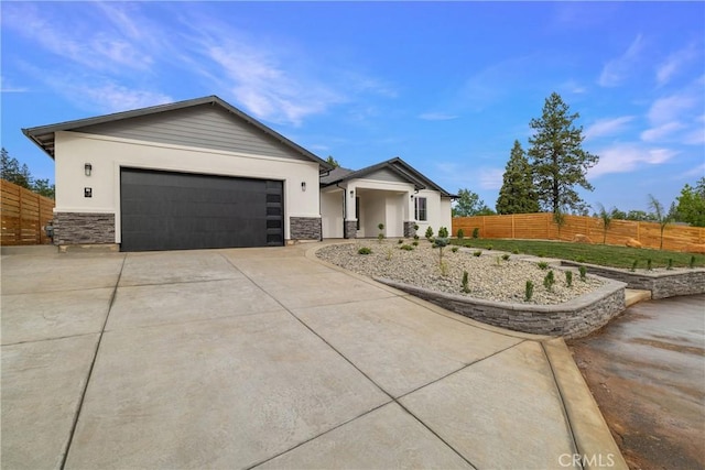 6638 Dolores Dr, Paradise, CA 95969 - view of front of property featuring stone siding, driveway, stucco siding, and a garage