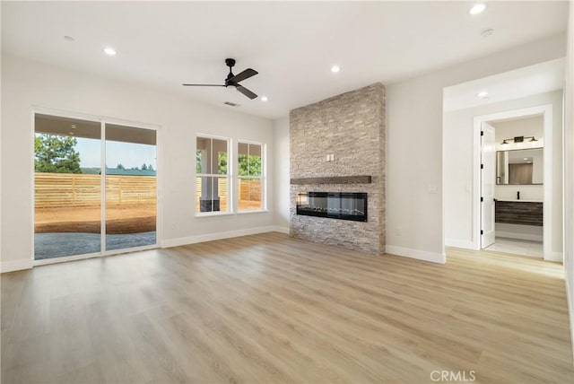 6638 Dolores Dr, Paradise, CA 95969 - unfurnished living room with ceiling fan, plenty of natural light, a stone fireplace, recessed lighting, and light wood-style floors