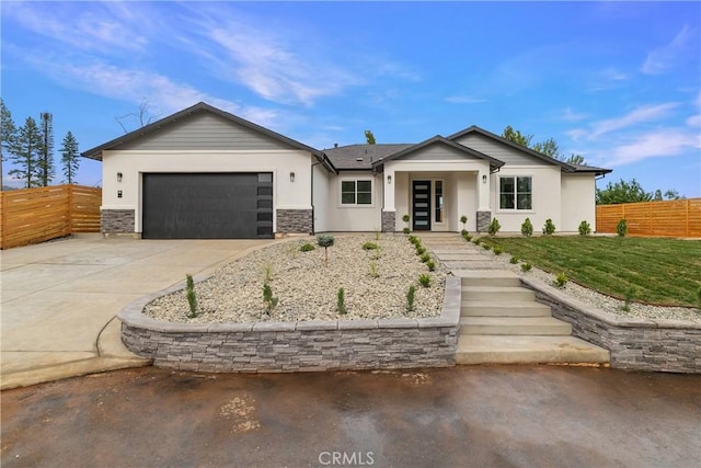 6638 Dolores Dr, Paradise, CA 95969 - view of front facade with driveway, a garage, stucco siding, and stone siding