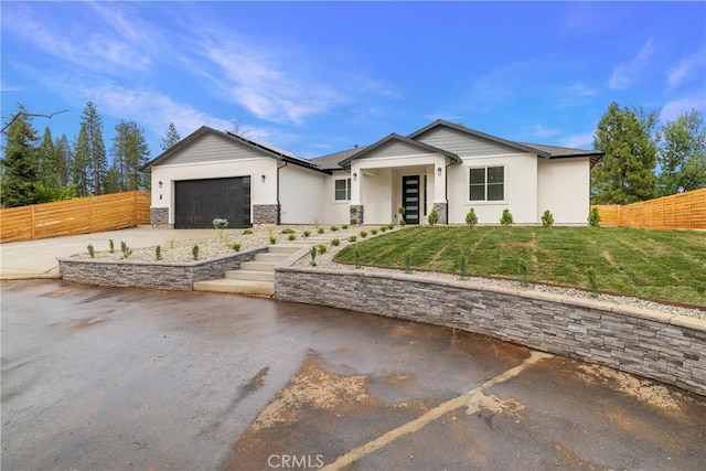 6638 Dolores Dr, Paradise, CA 95969 - view of front of house with driveway, an attached garage, stucco siding, and stone siding